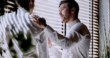 Man consoling a coworker at work