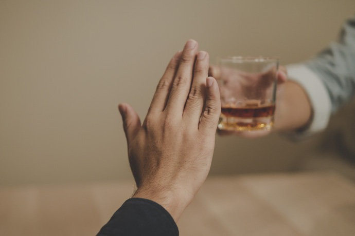 Persona rechazando bebidas alcohólicas